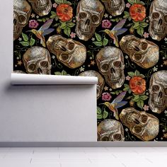 the wallpaper is decorated with skulls and flowers