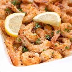 shrimp with lemon and parsley in a white dish