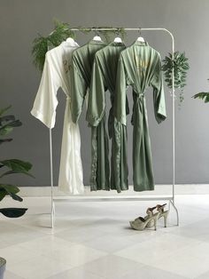 Discover the epitome of elegance with our bridesmaid robes, satin bridal robe, and silk bride robe--ideal for flower girl proposals and the perfect getting-ready outfit. Tailored for the mother of the groom and bridesmaids, our custom plus-size and personalized robes boast a very long kimono design in a sophisticated olive sage green hue. A thoughtful combination of liner, pockets, and personalized text enhances the overall appeal. A truly exquisite gift for tall women and girls, these robes ble Silk Bridal Robe, Dream Spa, Bridesmaid Robe Personalized, Bridesmaid Satin, Embroidered Robes, Wedding Getting Ready, Personalized Robe, Bridesmaid Boxes, Girls Robes