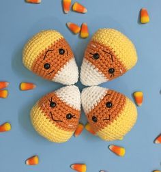 four crocheted candy candies arranged in the shape of two oranges and one white