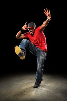 a man in red shirt doing a trick on a skateboard