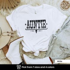 "ABOUT OUR AUNTIE SHIRTS This classic unisex jersey short sleeve tee fits like a well-loved favorite. ❤️ Soft cotton and quality print make users fall in love with it over and over again. These t-shirts have-ribbed knit collars to bolster shaping.  ✅ 100% Airlume combed and ringspun cotton (fiber content may vary for different colors) ✅ Light fabric  ✅ Retail fit ✅ Tear away label ✅ Printed and shipped from the USA ✅ Runs true to size -- Looking for a different color or size? Send us a message! 👉 CARE INSTRUCTIONS ✔︎ Wash inside out with like colors. ✔︎ Tumble dry or hang to dry. ✔︎ Try not to iron directly over the design. Iron if necessary! 🚚 HOW TO ORDER 1) Please, check and review all photos 2) Choose your shirt, sweatshirt or hoodie style, color, and size 3) Click add to cart. You c Birthday T-shirt With Relaxed Fit And Text Print, Unisex Letter Print T-shirt For Birthday, Unisex Birthday T-shirt With Letter Print, Relaxed Fit Short Sleeve T-shirt For Birthday, Crew Neck T-shirt With Lettering For Gift, Relaxed Fit T-shirt With Name Print For Birthday, Custom Print Relaxed Fit T-shirt For Birthday, White Relaxed Fit T-shirt For Birthday, Short Sleeve Tops With Lettering For Birthday