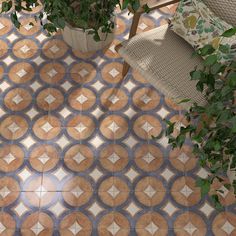 a potted plant sitting on top of a tiled floor next to a chair and table