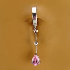 Silver belly ring with pink CZ dangle charm. Fixed to the bottom of the belly ring is a sterling silver with clear and pink cz dangle char,. No other body jewelry offers the convenience, security and beauty of real jewelry like TummyToys. All TummyToys belly button rings are created with you in mind they are comfort fit and will not snag on clothing. Our easy to use patented snap-in design makes it the world's best navel ring. No more struggling with and loosing tiny balls from standard barbells Unique Belly Rings, Gold Belly Ring, Belly Button Jewelry, Jordan Shoes Retro, Navel Ring, Button Rings, Real Jewelry, Navel Rings, Skull Jewelry