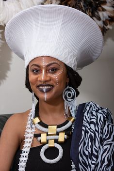 This elegant Zulu Basket Hat in white is the perfect accessory to upgrade any outfit. This piece is handmade by female artisans in South Africa. The hat is made out of woven grass, polyester cloth patterned with cotton, wool threads, and decorative glass beads. It can be worn on special occasions like birthdays, weddings, and formal gatherings. As with all handmade items, no two pieces are the same. Dimensions: Head Size: Comes in 22" and 24" *Also comes in black - Head Size: 23" Zulu Hats South Africa, African Bridesmaids, Dressy Hats, Black Woman Artwork, African Traditional Wedding, African Head Wraps, Zulu, African Wedding, Women Artisans