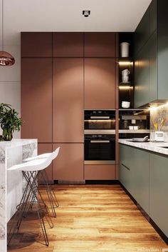 a modern kitchen with marble counter tops and wooden flooring, along with bar stools