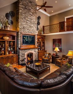 a large living room with couches and a fireplace