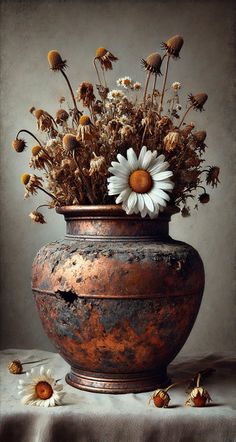 a vase filled with lots of flowers on top of a table