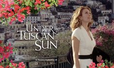 a woman standing in front of flowers with the words under the tuscan sun