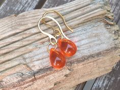 These beautiful little drop earrings are made with a smooth orange Czech glass teardrop. These are light and lovely earrings to wear every day, to dress up a casual outfit or for a special occasion. The drop beads are top quality czech glass, beautiful clear shade  and intens clarity of colour and glossy finish. Colour varies depending on the light conditions from light to dark. Teardrop size is 10 x 14 mm (approximately 1/2 inch). The whole length from the top of the ear hook is 30 mm (1,18 in) Orange Teardrop Earrings As Gift, Amber Teardrop Earrings Gift, Amber Teardrop Earrings As A Gift, Amber Teardrop Drop Earrings For Gift, Handmade Orange Teardrop Earrings For Gift, Handmade Orange Teardrop Earrings, Orange Teardrop Jewelry With Matching Earrings, Lilac Earrings, Earrings Classic