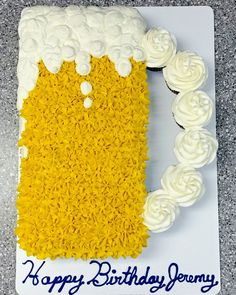 a birthday cake made to look like a beer mug with white frosting on it