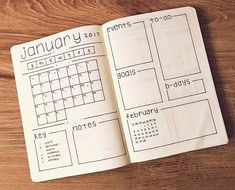 an open planner book sitting on top of a wooden table