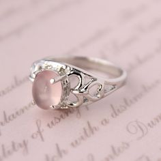 Presenting you A Beautiful Rose Quartz Ring In Filigree  Style Shank Ring with Oval Cabochon Rose Quartz . The color of the cabochon used is really soothing to the eyes. Perfect Gift For Her or as a proposal Ring or you can gift yourself Item No: skj.18.501 Item: Pink Quartz Ring in 925 Sterling Silver Primary Stone: Pink Quartz Secondary Stone:-- Article Weight: 5.1 gms primary stone Size: 9x7  mm Ring Length: 2.1 cm Ring Width: 1.1 cm Maintenance Tips 1. Keep the jewelry away from direct heat, water, perfumes, deodorants, and other strong chemicals.  2. Wipe the Jewellery gently with a chamois cloth or leather swatch after every use.  3. Wiping the jewelry with a soft cloth after removing the jewelry would a PAYMENT POLICY  PAYMENT THROUGH PAYPAL ONLY. SHIPPING POLICY Processing time for Sterling Silver Oval Rings For Valentine's Day, Silver Oval Rings For Valentine's Day, Rose Gold Oval Moonstone Ring, Oval Rose Gold Moonstone Ring, Pink Oval Moonstone Ring In Sterling Silver, Pink Oval Cabochon Jewelry For Wedding, Pink Oval Cabochon Wedding Jewelry, Elegant Pink Oval Cabochon Ring, Elegant Oval Rose Quartz Rings