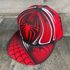 This is an airbrushed snapback hat featuring a Red Spider design.  This hat is adjustable and will fit almost anyone.  These hats are waterproof and can withstand a good soaking but they should not be washed in a washing machine or dish washer.  Thank you, Brad. Shipping is free for this item anywhere in the US. Airbrush Clothes, Spider Design, Red Spider, East Lansing, Lansing Mi, Dish Washer, Motorcycle Helmets, Snapback Hat, Snapback Hats