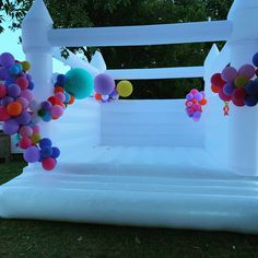 an inflatable arch decorated with balloons and streamers