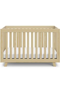 a small wooden crib with white sheets on the bottom and side rails, in front of a white background