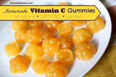 there is a white plate with yellow gummys on it and the words, homemade vitamin c gummies