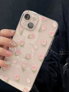 a woman's hand holding an iphone case with pink flowers on it