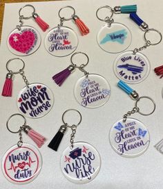 a bunch of key chains that have some tassels on them with different colors