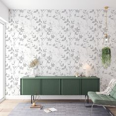 a living room with a green cabinet and wallpaper on the walls next to a chair