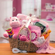 a pink baby gift basket filled with toys