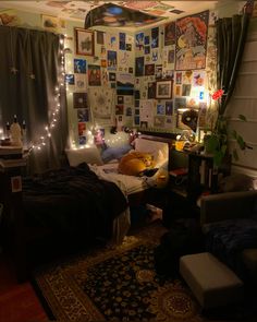 a bed room with a neatly made bed and lots of pictures on the wall