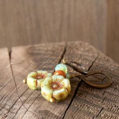 "This listing is for these vintage style, glass beaded, dangle earrings. They are wonderful mint green flower beads, orange brown, and a pale aqua with a touch of green. They are part of my coral pink and mint series. All the items from this series can mix and match. These earrings are 1.5 inches in length. They are light weight and comfortable. The smaller bead is 3 x 5mm in size, the Hibiscus flower bead is 12mm. This is available in a vintage look with antique brass (as shown), hypoallergenic Retro Beaded Jewelry For Gifts, Retro Beaded Jewelry Gift, Retro Beaded Jewelry As Gift, Vintage Czech Glass Matching Earrings, Vintage Adjustable Beaded Earrings, Retro Beaded Dangle Jewelry, Vintage Beaded Round Earrings, Vintage Beaded Earrings For Gift, Vintage Czech Glass Flower Earrings For Gift