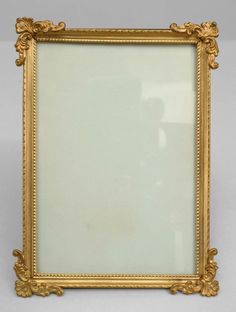 an ornate gold framed mirror on a white background