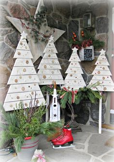 christmas trees and decorations on display in front of a fireplace