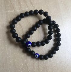 Set of 2 Evil Eye Bracelets Black Onyx 8mm beads 1 Blue Glass Evil Eye Bead Gift Packaging included (box and pouch) Free Shipping in USA Handmade in USA 7” and 7.5” in length window.dataLayer = window.dataLayer || []; function gtag(){dataLayer.push(arguments);} gtag('js', new Date()); gtag('config', 'AW-645572217'); Black Evil Eye Bracelet With 8mm Beads For Gift, Black Beaded Bracelet With Evil Eye, Spiritual Black Evil Eye Bracelet With 8mm Beads, Black Evil Eye Bracelet With 8mm Beads As Gift, Black Evil Eye Round Beads Jewelry, Black Evil Eye Bracelet With Round Beads As Gift, Black Beaded Evil Eye Bracelet With Round Beads, Black Evil Eye Bracelet With Round Beads, Gemini Jewelry