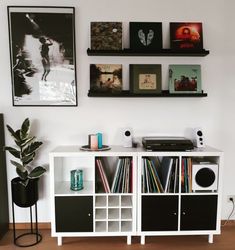 a white entertainment center with black and white shelves