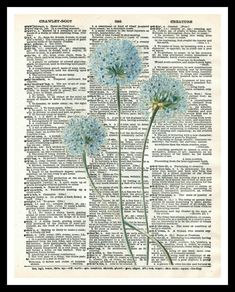 two blue flowers sitting on top of an old book page with words written in it