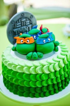 there is a cake that has two teenage mutant turtles on it