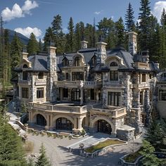 this is an aerial view of a luxury home in the mountains with pine trees surrounding it