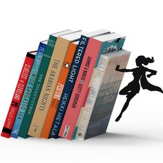 a stack of books with a silhouette of a girl holding an umbrella in front of them