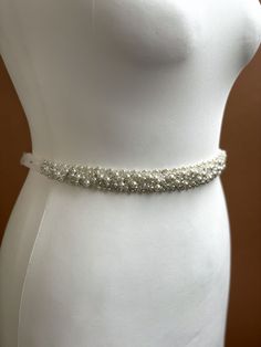 This gorgeous pearl bridal sash will be a perfect finishing to your elegant bridal outlook. Handmade of real pearls, premium quality crystals and rhinestones, this wedding waist chain will add a sparkle and shine to your look. Features a layered pearl and rhinestones chain, floral embroidered applique, this flower waist belt is an amazing choice for a floral style wedding.   This wedding sash can be tied around the waist with hook or ribbon closure to a custom length you want.   Please, let me k Wedding Belts And Sashes Pearl, Bedazzled White Bridal Belt For Wedding, White Pearl Embellished Sashes For Wedding, Beaded Crystal Bridal Belt For Wedding, Crystal Beaded Bridal Belt For Wedding, Wedding Bridal Belt Beaded With Pearls, Wedding Bridal Belt With Beaded Pearls, Wedding Pearl Beaded Bridal Belt, Elegant Silver Bridal Belt With Pearl Embroidery