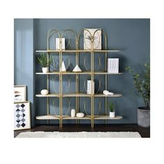 a book shelf with several shelves on top of it in front of a blue wall