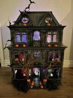 an elaborate halloween house with pumpkins and decorations