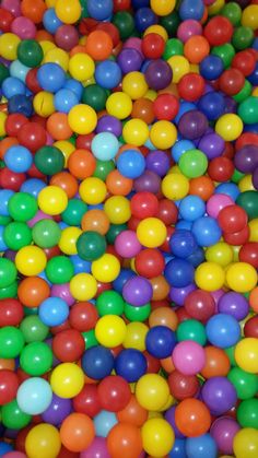 many different colored balls are scattered together in a ball pit with no people around them