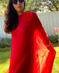 "Chiffon for days! This 60s I. Magnin red gown is a real stunner. Long sheer sleeves, layers of chiffon, huge sweep with the sweetest corsage at the shoulder. Back zipper closure, with snaps to close the top layer. Excellent vintage condition. Has a few spots at the back of the hemline. Dried cleaned. No size tag or fabric tag. Laid flat: 15\" Shoulder to shoulder  21\" pit to pit  20\" Waist  22\" Hips  56\" Long  24\" sleeves" Long Sleeve Silk Chiffon Dress For Party, Silk Chiffon Long Sleeve Dress For Parties, Red Floor-length Gown For Wedding Guest, Red Chiffon Party Gown, Red Georgette Evening Dress, Red Long Sleeve Organza Dress, Flowy Red Chiffon Long Sleeve Dress, Red Long Sleeve Chiffon Maxi Dress, Red Long Sleeve Dress For Beach Cover-up