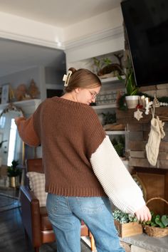 a woman standing in front of a tv with her arm wrapped around the television screen