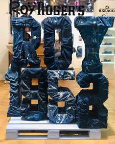 the letters are made out of plastic bags and have been placed on top of each other