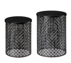 two black and white metal side tables with intricate designs on the top, one is round