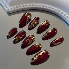 💖Just Nails - Handmade Press-On Nails💖 Design Notes - Colors are fully customizable (personalization box) - Red gel base with blended black pigment - Gold chrome abstract flourishes - Pictured: size small short almond - Because they are handmade to order, each set is unique ✨Product Description✨ - All sets are made to order - All sets are pre-etches for longer lasting nails - Each set includes:     - mini buffer     - wooden cuticle stick     - alcohol prep pad     - one tube of nail glue Red Black And Gold Acrylic Nails, Shiny Burgundy Nails, Red And Gold Flake Nails, Red Nails With Gold Details, Gold With Red Nails, Red And Gold Cat Eye Nails, Red Nails Gold Design, Christmas Nail Acrylic Ideas, Gold Designs On Nails