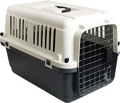 a white and black dog carrier with its door open