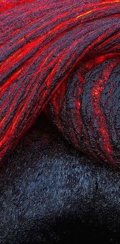 red and black yarn is laying on top of each other in this close up photo