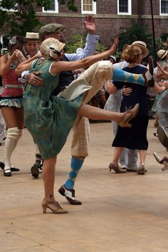 a group of people are dancing in the street