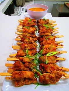 chicken skewers with dipping sauce on the side