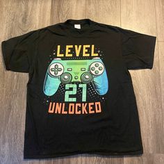 For The Birthday Gamer In Your Life. 100% Cotton T-Shirt With Gaming Theme And “Level 21 Unlocked” Written In Bricks. Nwot. Never Worn, Perfect Condition Other Than The Screen Print Looks A Bit Off-Centered If You Really Pay Attention. Size Xl. See Photos For Measurements. Smoke-Free And Pet-Friendly Home. Bundles And Offers Welcome-Save On Shipping! Black Gamer T-shirt With Letter Print, Black Top With Text Print For Birthday, Black Tops With Text Print For Birthday, Black Gamer T-shirt With Screen Print, Casual Black T-shirt For Birthday, Casual Short Sleeve T-shirt For Birthday, Black Gamer T-shirt With Graphic Print, Black Gamer Tops With Logo Print, Black Short Sleeve Gamer T-shirt