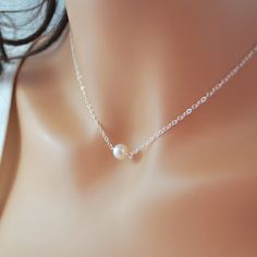 "This freshwater pearl choker is so delicate and pretty. A creamy white, genuine pearl is centered on fine, sterling silver chain. This lovely pearl is almost perfectly round and measures about 6-7mm in diameter. The pearl sits right at the hollow of your throat, making this a great layering piece. Little pearls connect the sterling lobster clasp. Prefer gold? Click below for the gold-filled version of this necklace: http://www.etsy.com/listing/155980428/new-white-pearl-choker-freshwater-pearl?r Curved Bar Necklace, Single Pearl Necklace, Simple Silver Jewelry, Diamond Bar Necklace, Floating Necklace, Single Pearl, Fine Silver Jewelry, Silver Jewelry Necklace, Pearl Choker Necklace